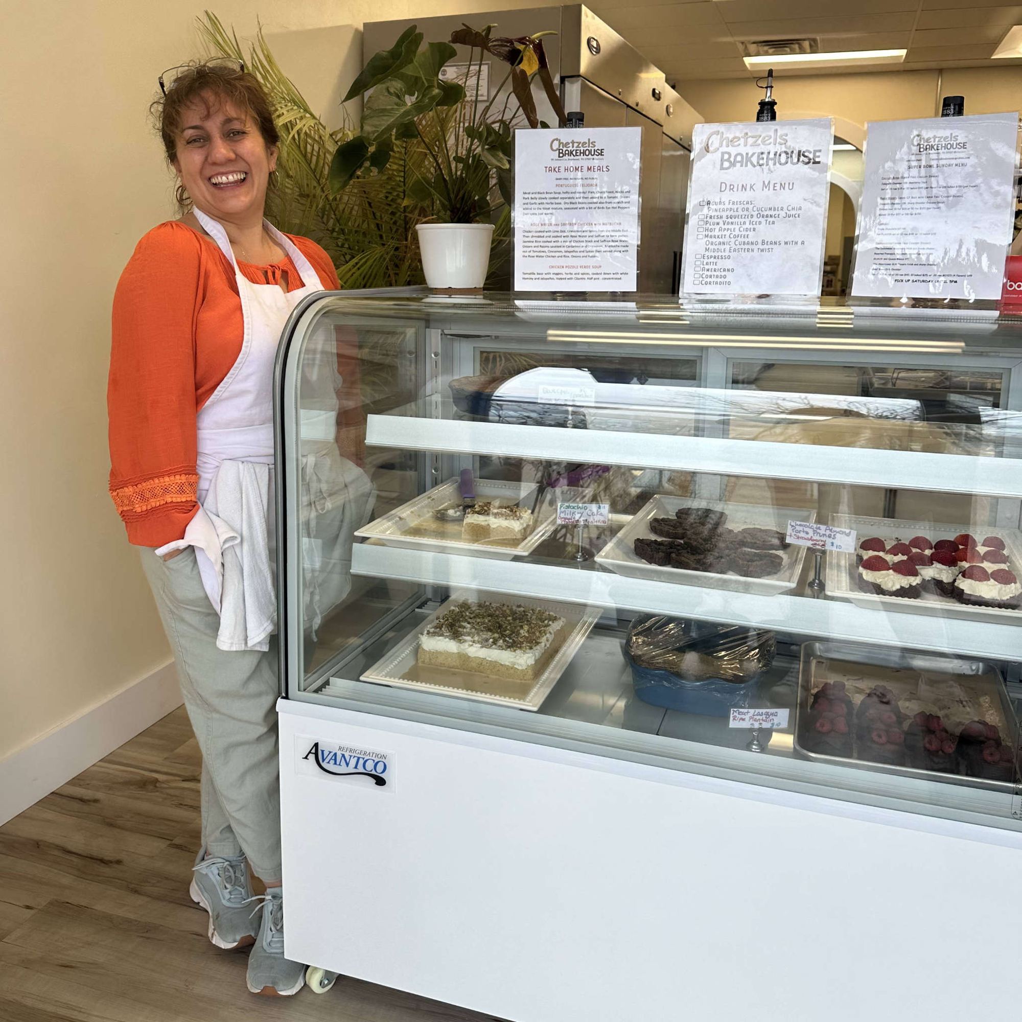 Inside Chetzels Bakehouse, standing by the pastry case