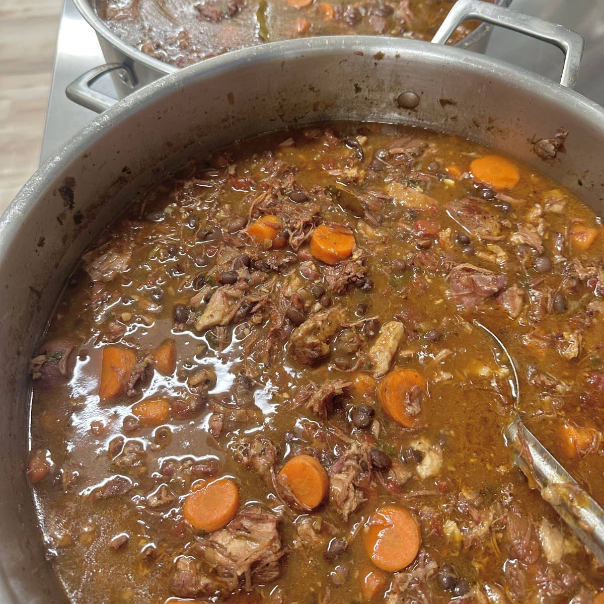 A big pot of stew with carrots