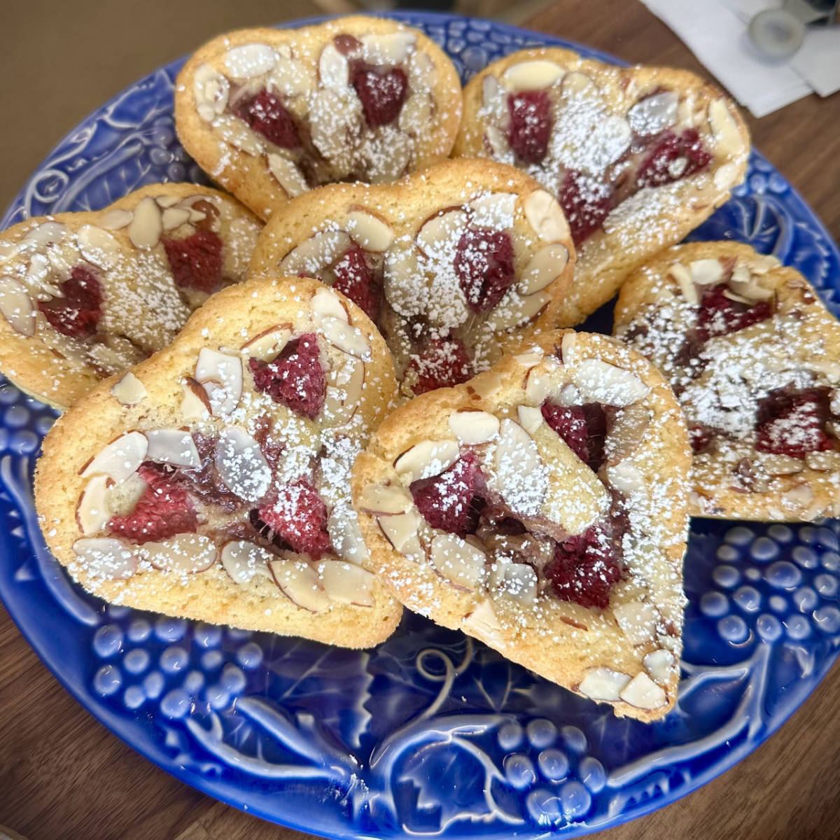 Raspberry almond tarts on a blue plate